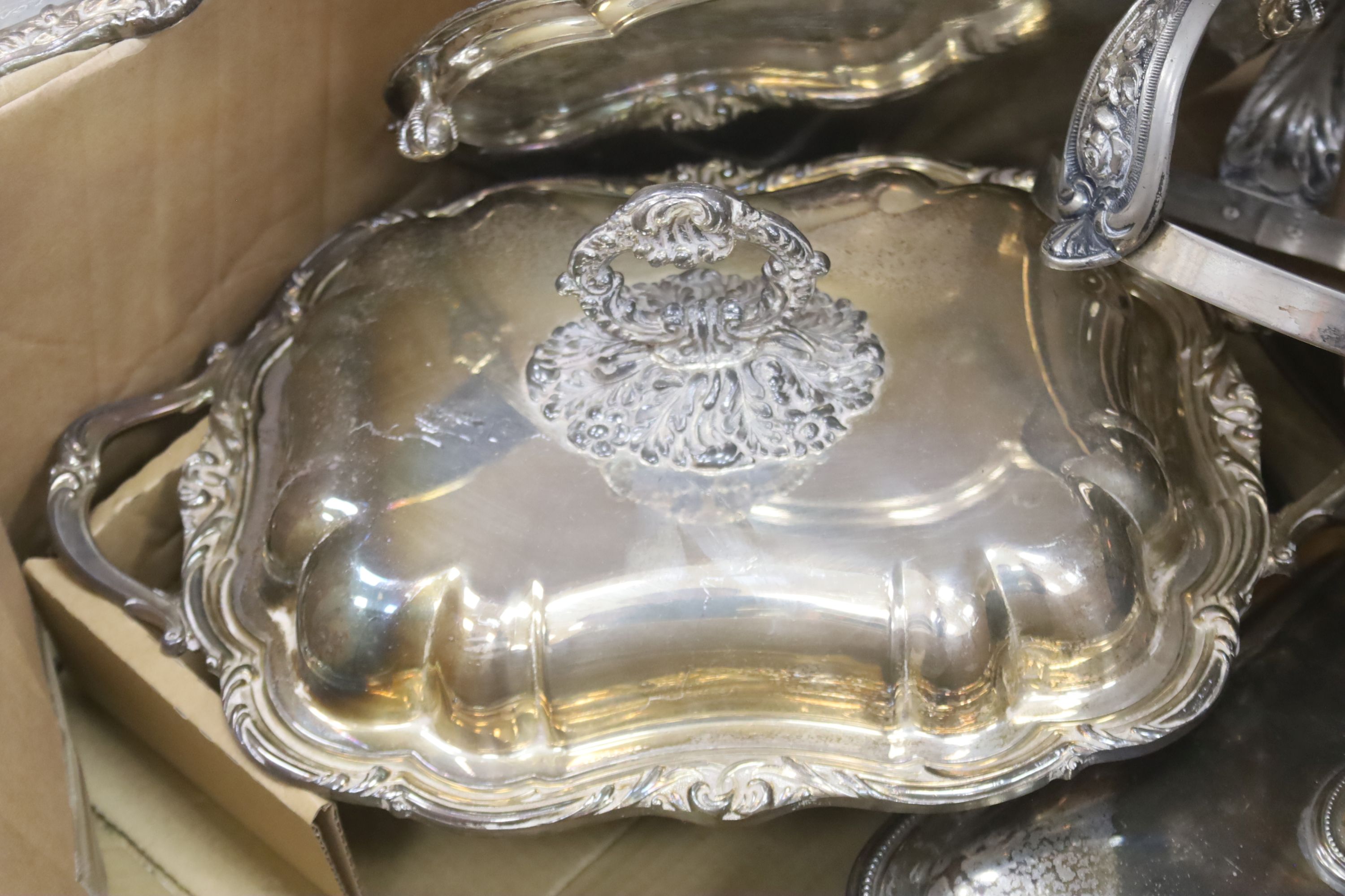 A quantity of plated wares to include tureens and covers, chargers etc.